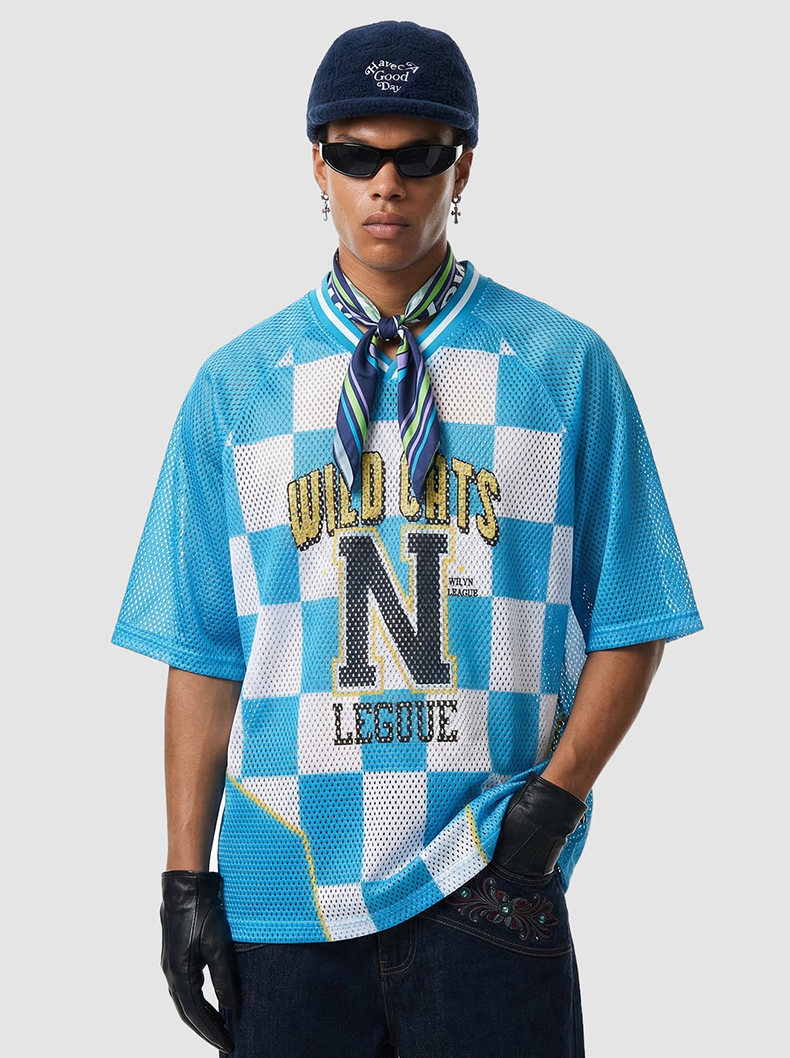 Blue checkerboard mesh jersey T-shirt with Wild Cats N League graphic, worn with scarf, sunglasses, and cap