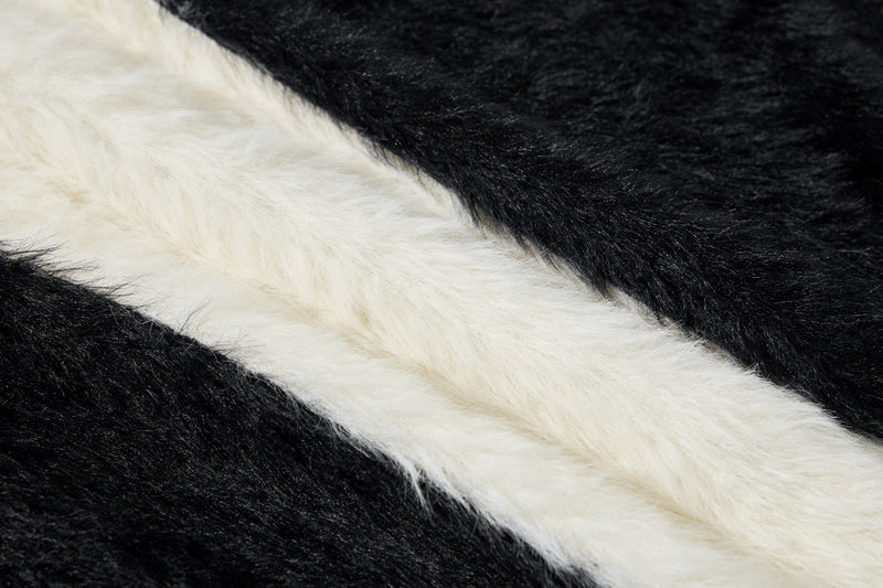 Close-up of black and white fuzzy fabric with diagonal stripe pattern