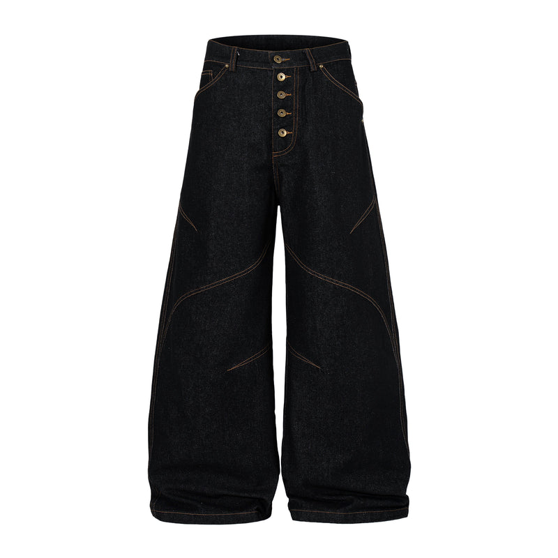 Front view of black wide leg denim pants with curved panel seams and high-rise button fly