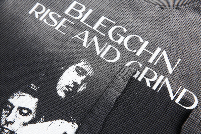 Close-up of front graphic text on black waffle knit long sleeve tee