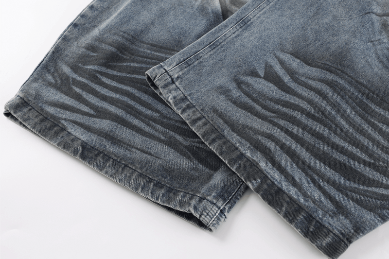 Folded hem detail of faded blue denim jeans
