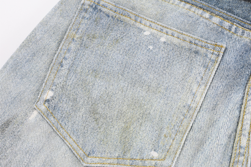 Close-up of back pocket on light wash denim with subtle distressing