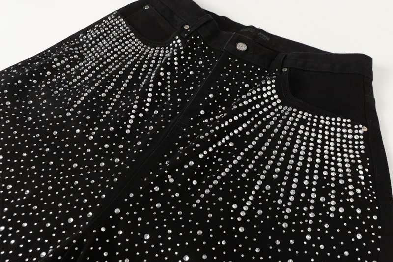 Close-up of black jeans front waist with radiating rhinestone pattern