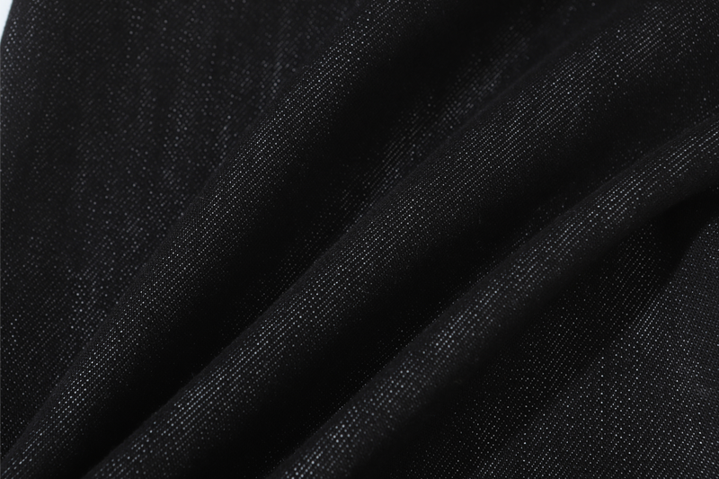 Close-up of black denim fabric with subtle diagonal weave texture