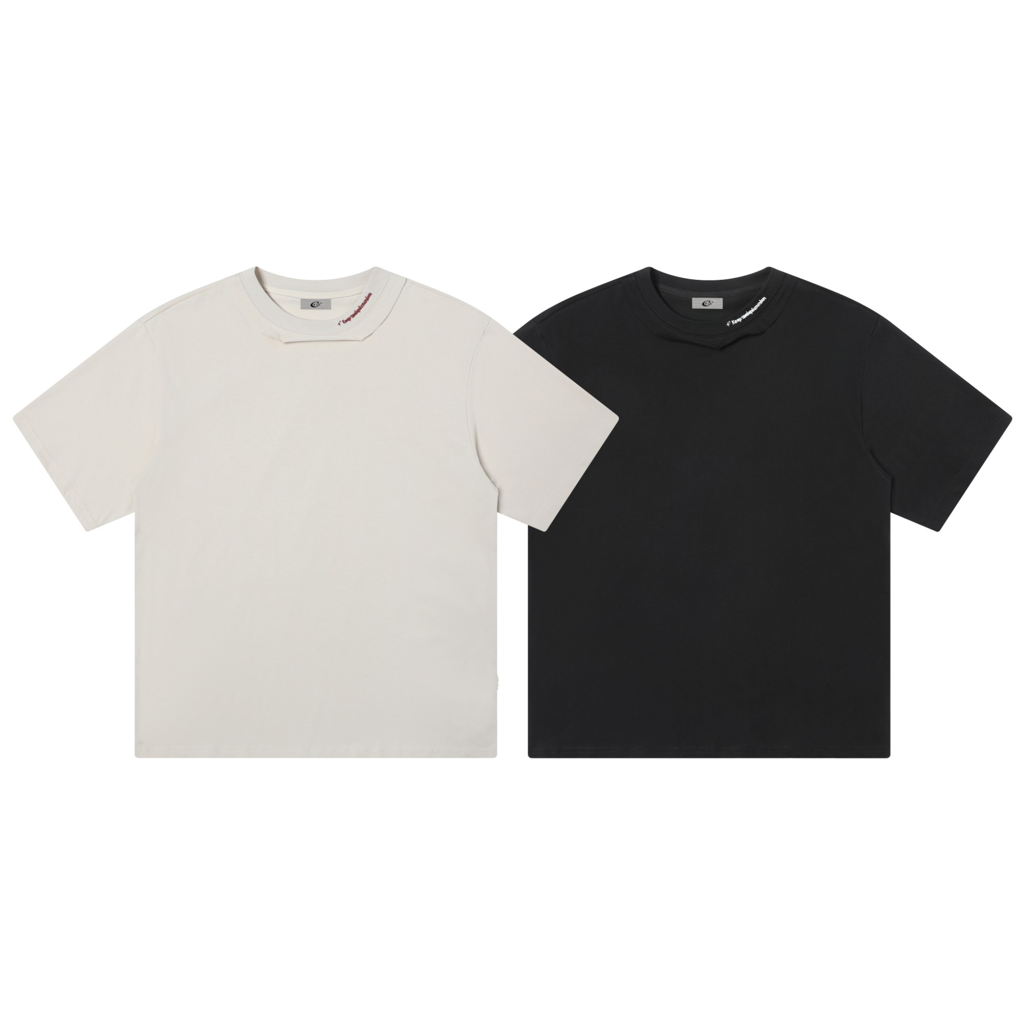 Flat lay of two plain oversized t-shirts side by side in off-white and black with asymmetric deconstructed collar detail
