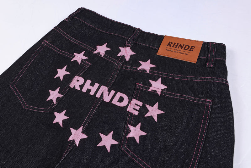 Back waistband close-up with pink star embroidery and RHNDE leather patch