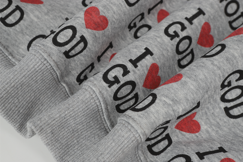 Close-up of hoodie sleeve cuffs with gray rib knit and I Love God print