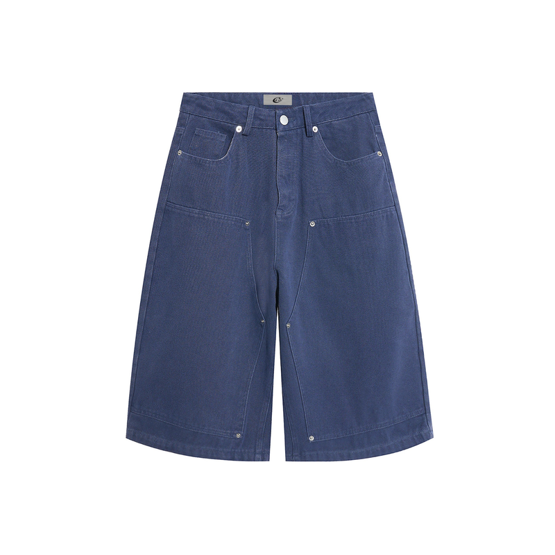 Blue wide-leg denim jorts front view with five pockets, metal rivets, and textured canvas fabric