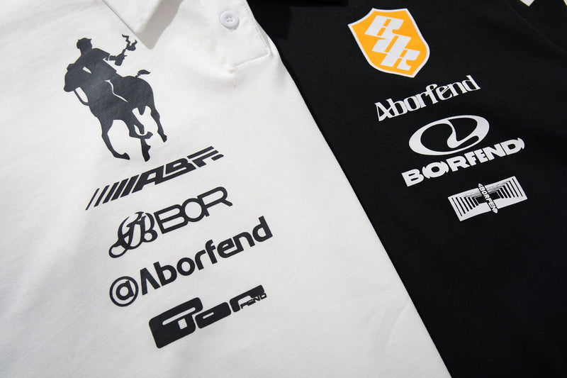 Black and white racing crest polo shirts with motorsport sponsor graphics and bold logo prints on the chest