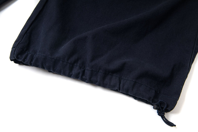 Black pants hem close-up with drawcord and stitched cuff detail