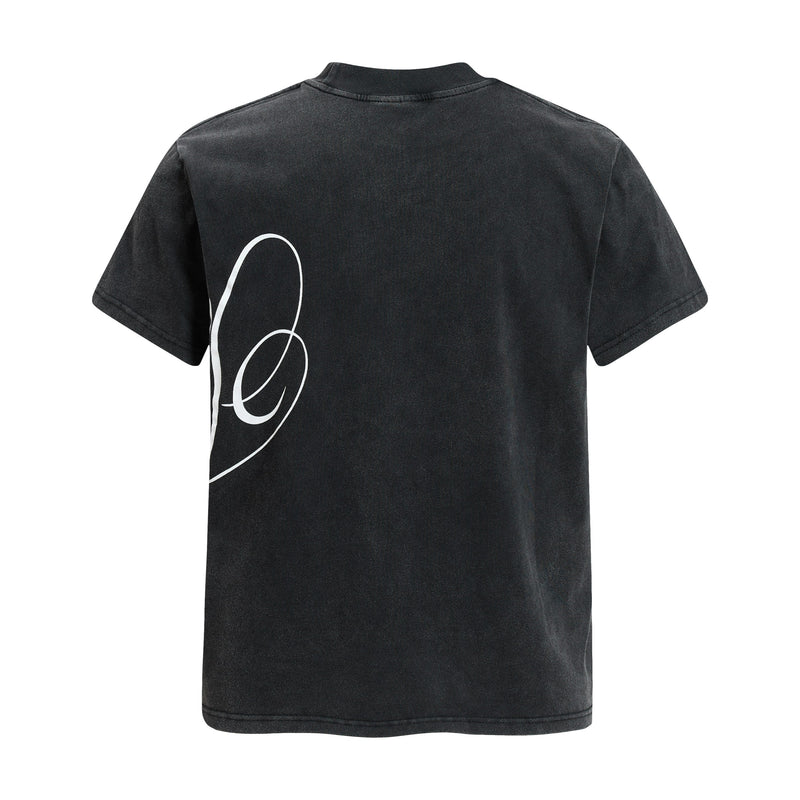 Black washed streetwear tee with a white abstract crest graphic on the back and a ribbed crew neckline
