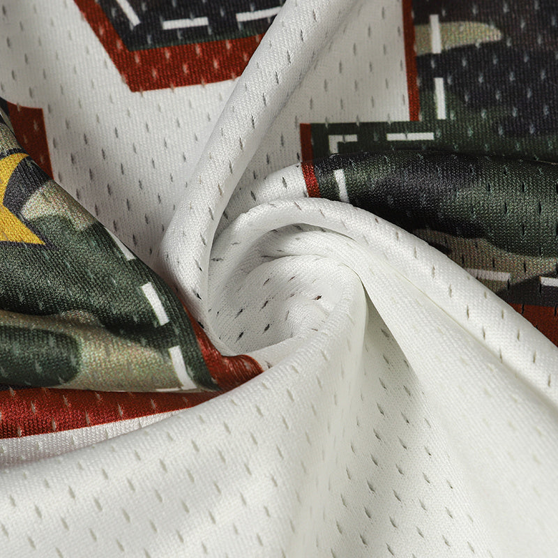 Close-up of Seakoff camo varsity football jersey fabric with white mesh and camouflage print, featuring number 24 details