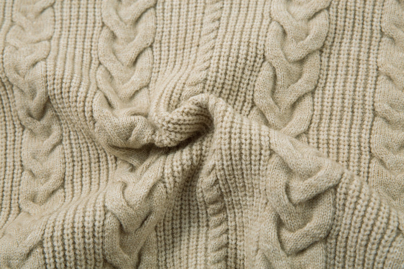 Beige cable knit jacket knit texture close-up with folded sleeve detail