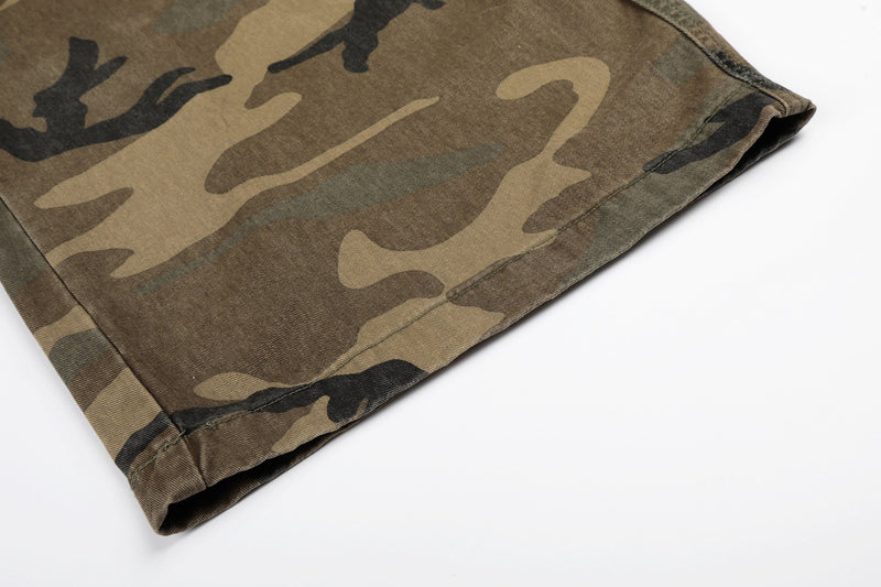 Close-up of hemmed leg opening on camouflage denim cargo jeans