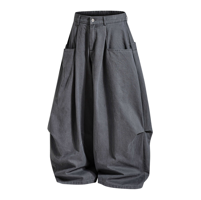 Dark gray wide-leg pants angled front view with pleats, button waist, and cargo pockets