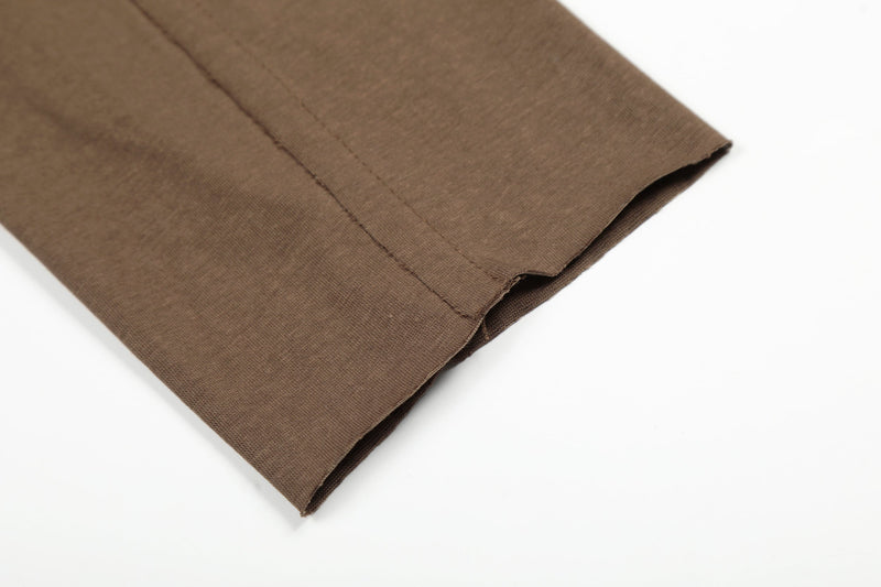Close-up of brown long sleeve T-shirt cuff hem and side seam