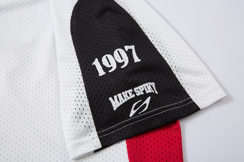 Black and white mesh polo sleeve with 1997 graphic and red colorblock accent, close-up streetwear jersey detail