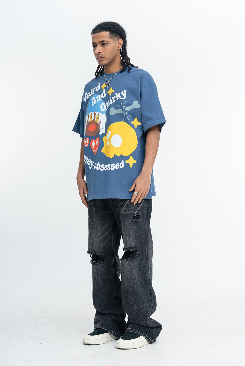Blue oversized streetwear tee with quirky money-obsessed graphic, worn with distressed black jeans and sneakers