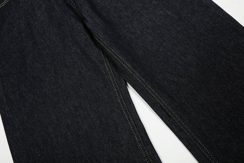 Close-up of dark wash denim leg with center seam stitching