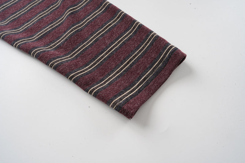 Maroon striped long sleeve close-up with thin beige and black horizontal stripes