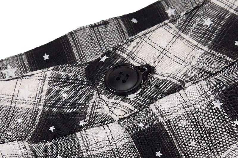 Close-up of black button on plaid cargo shorts with star pattern