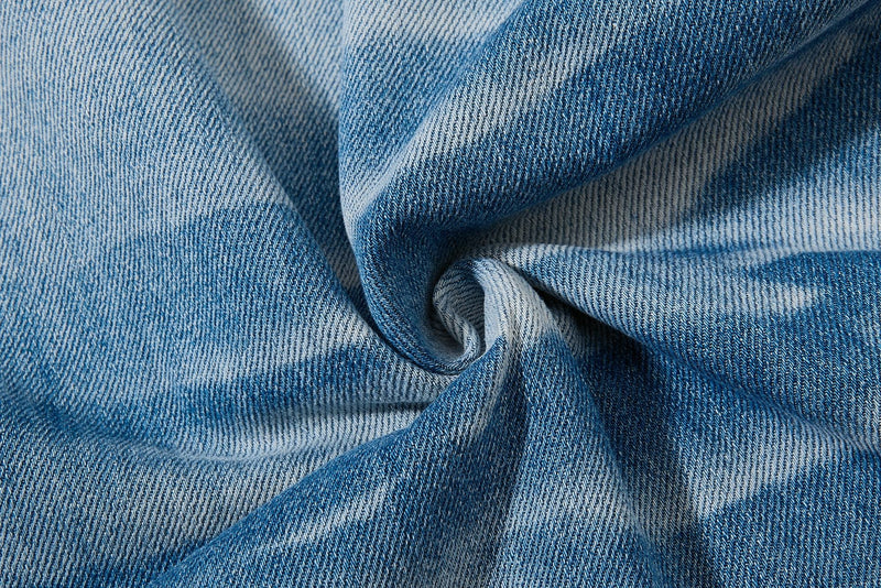 Close-up of folded light and dark blue denim fabric texture