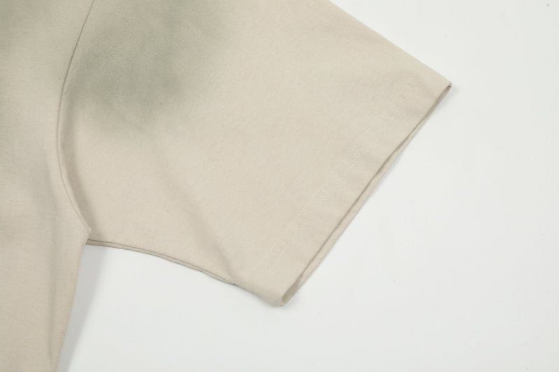 Beige washed oversized tee sleeve with vintage faded fabric and clean hem detail