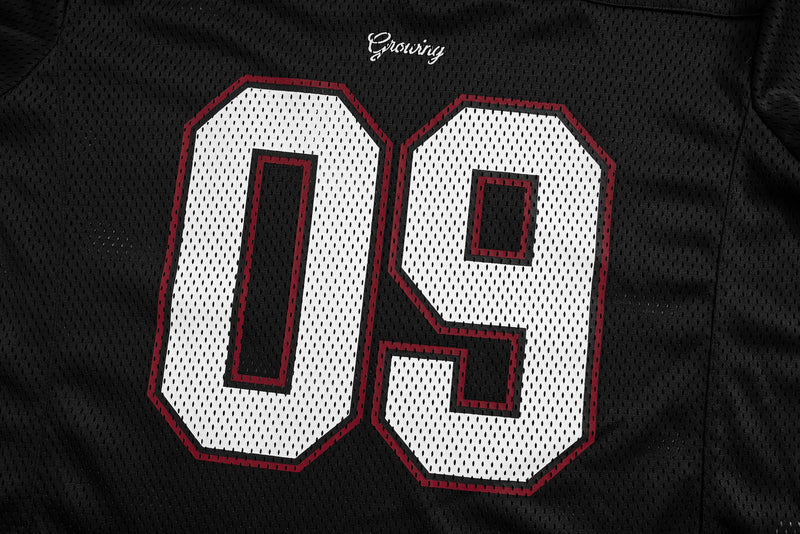 Black mesh jersey chest close-up showing white 09 numbers with red outline