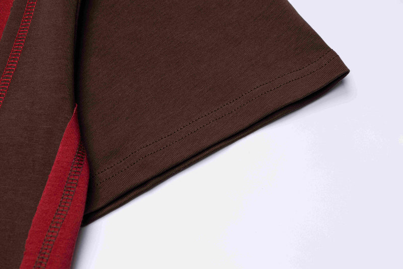 Close-up of a brown oversized T-shirt sleeve with red retro side stripes and visible hem stitching