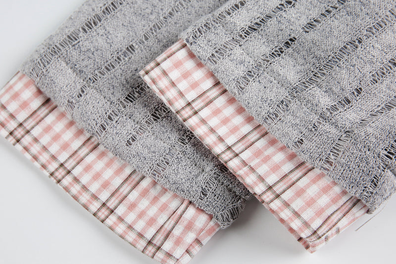 Cuffs of gray mesh top with pink plaid sleeve lining, close-up