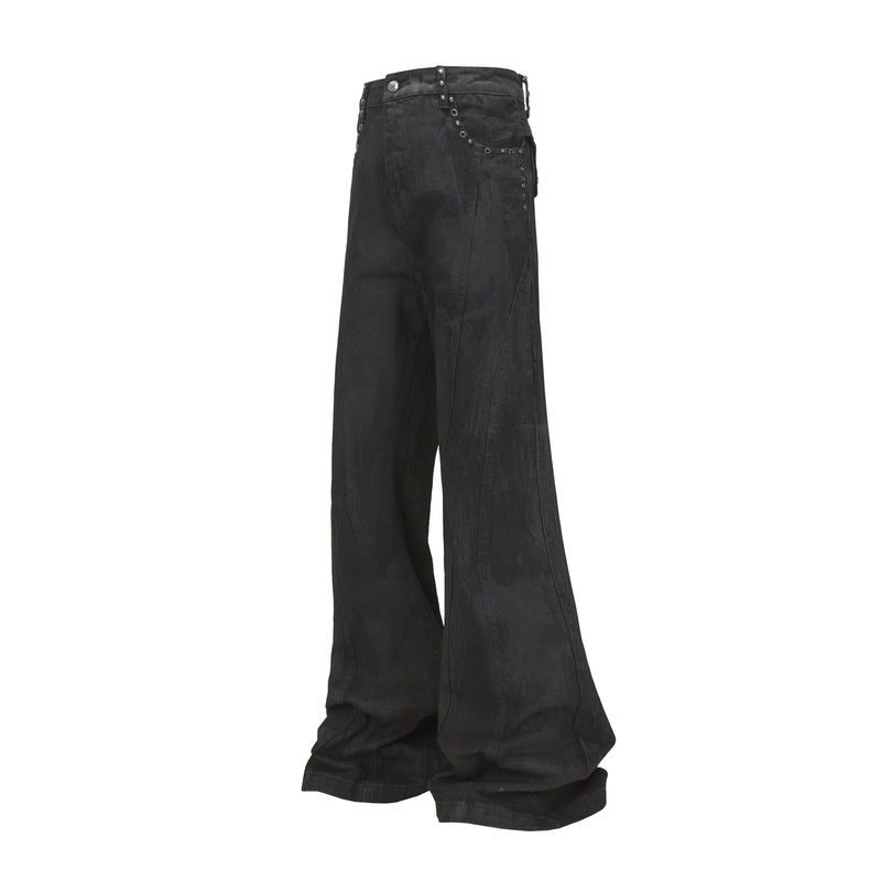 Front view of black wide-leg jeans with studded panel detailing and a flared hem