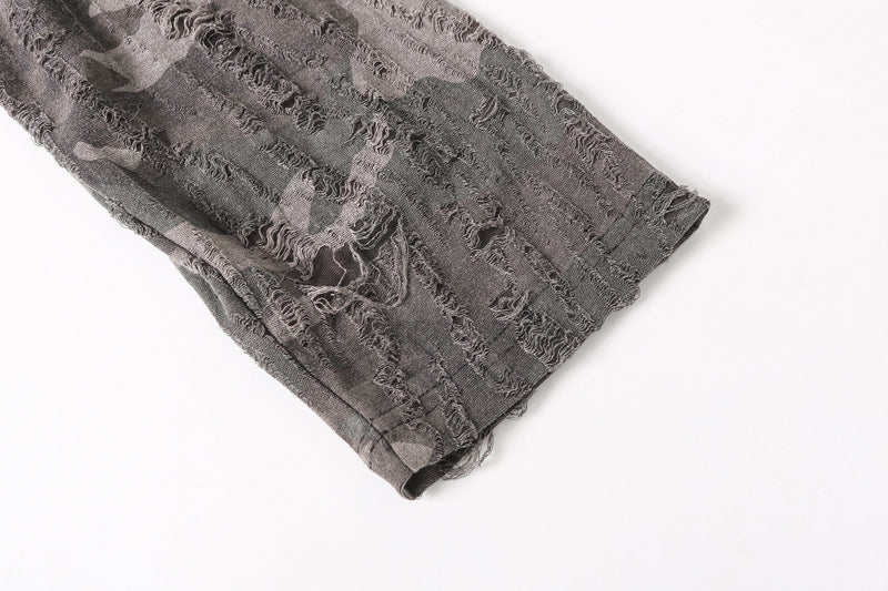Close-up of camo mesh long sleeve cuff with distressed texture