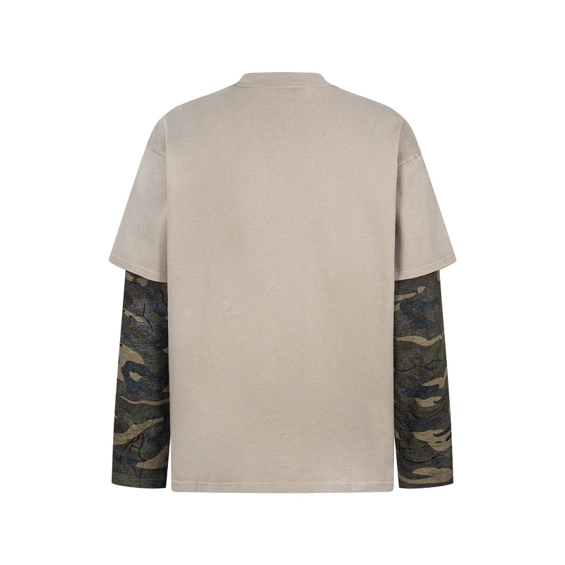 Back view of beige layered tee with camouflage long sleeves and distressed cutout details