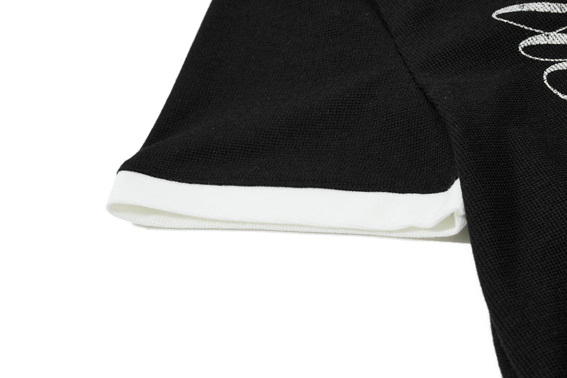 Black textured polo shirt sleeve with white contrast hem and star skull graphic detail
