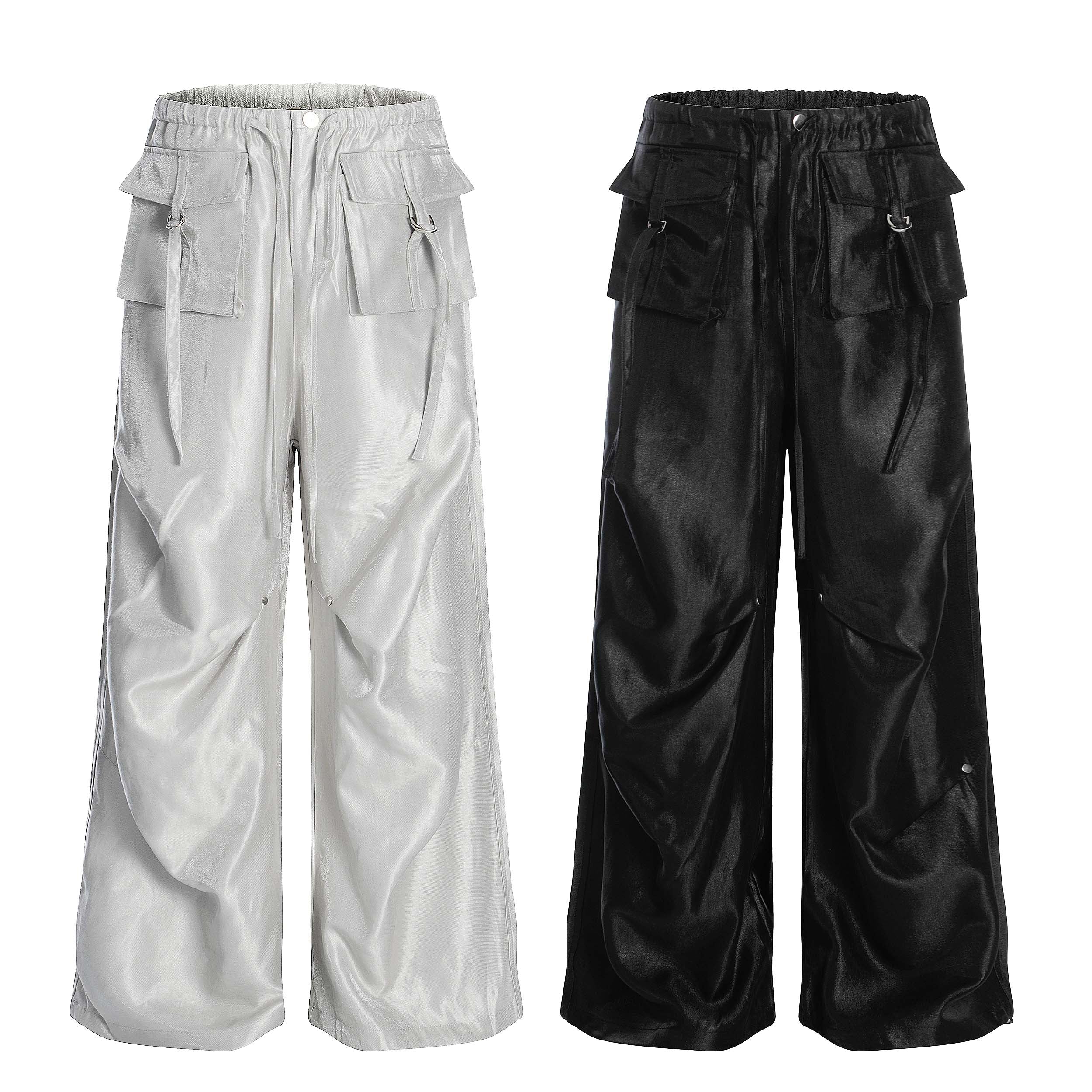 Omirad glossy utility cargo pants in silver and black, wide barrel leg with 3D flap pockets and metal hardware on white backg