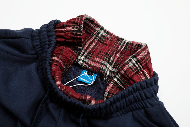 Inside waistband close-up with red plaid lining and woven size tag