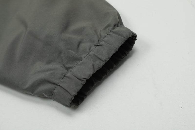 Close-up of elastic cuff on dark gray windbreaker sleeve