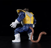 The Seakoff Great Ape Vegeta Collectible Figure from Dragon Ball Z stands at 36cm, showcasing a humanoid character with a tail and spiky hair. Dressed in blue armor, yellow chest plate, white gloves and boots, this premium action figure is posed against a black background, facing away.