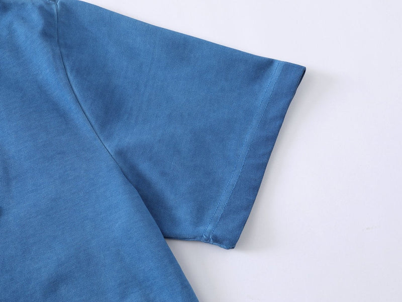 Blue streetwear T-shirt sleeve detail on a plain white background with soft cotton texture and clean stitching
