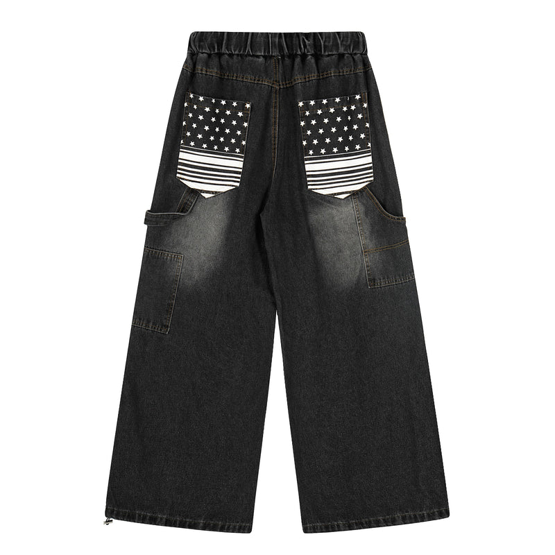 Back view of black washed wide-leg denim pants with star and stripe patch pockets