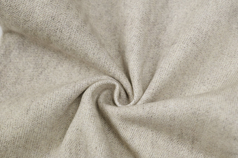 Close-up of beige denim fabric texture with soft fold