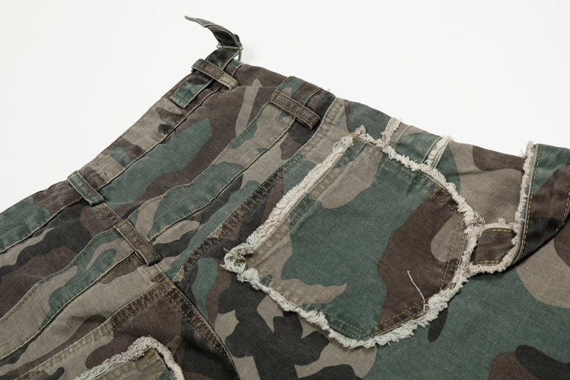 Close-up of the back waist and pocket flaps on camo jeans with frayed trim