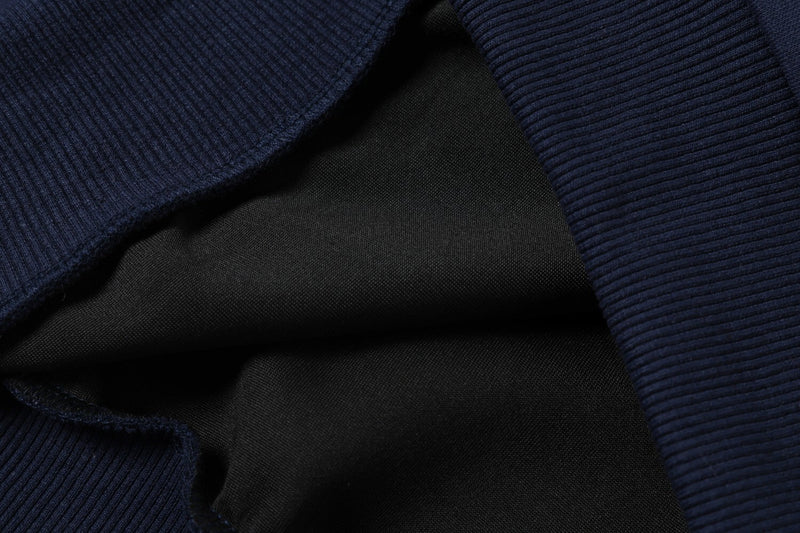 Close-up of layered knit fabric in navy and black
