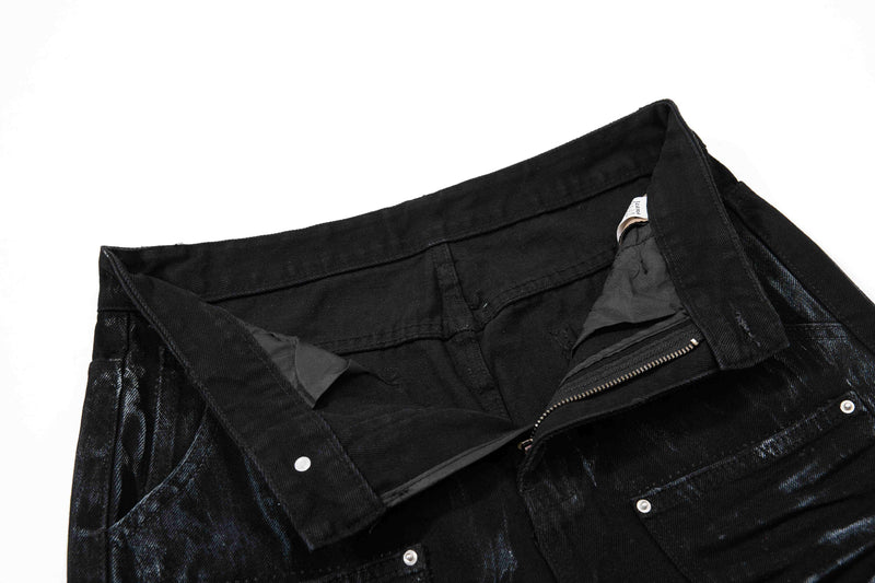 Inside waistband view of black jeans with zipper and snap closure
