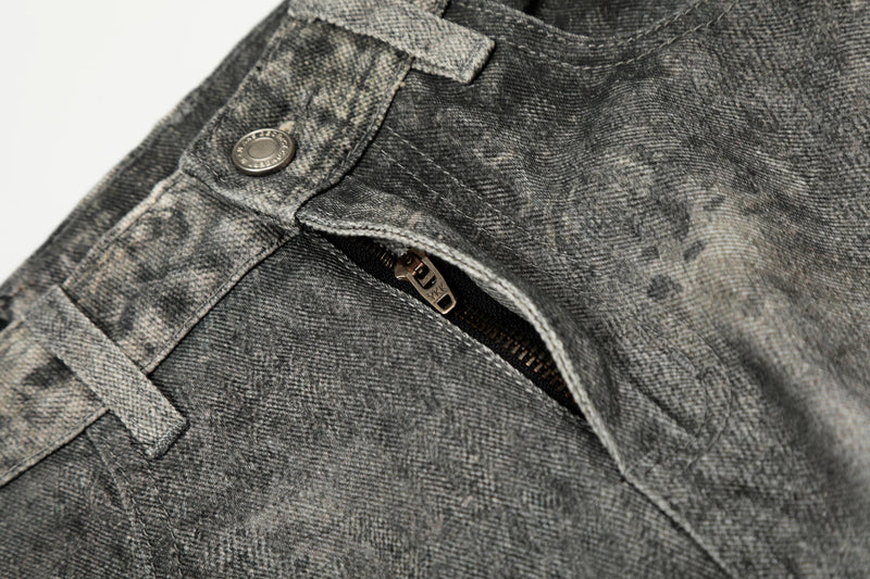 Close-up of front fly and button on washed curved denim pants