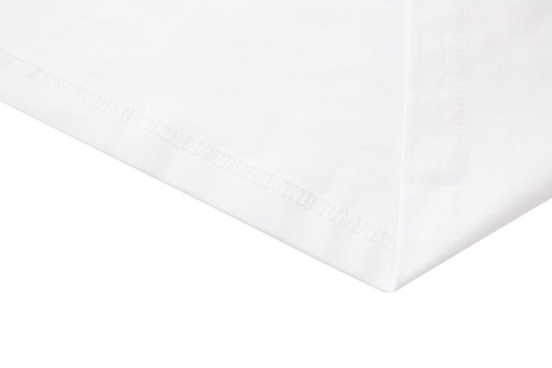 Close-up of a white retro football jersey tee with visible hem stitching and smooth streetwear fabric