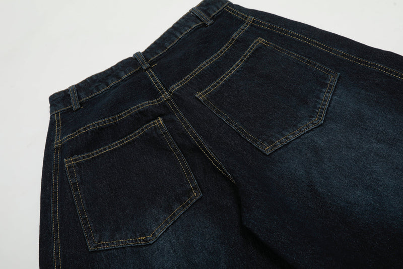Close-up of back pocket and yoke stitching on dark wash denim pants