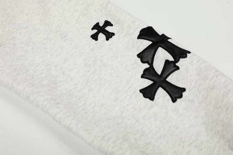 Close-up of black sleeve graphics on light gray hoodie