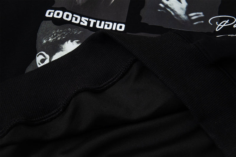 Close-up of black hoodie sleeve cuff and printed chest area