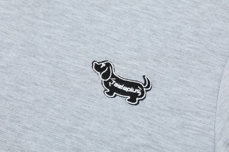 Close-up of a light gray Seakoff polo shirt with a small black embroidered dachshund logo on the chest